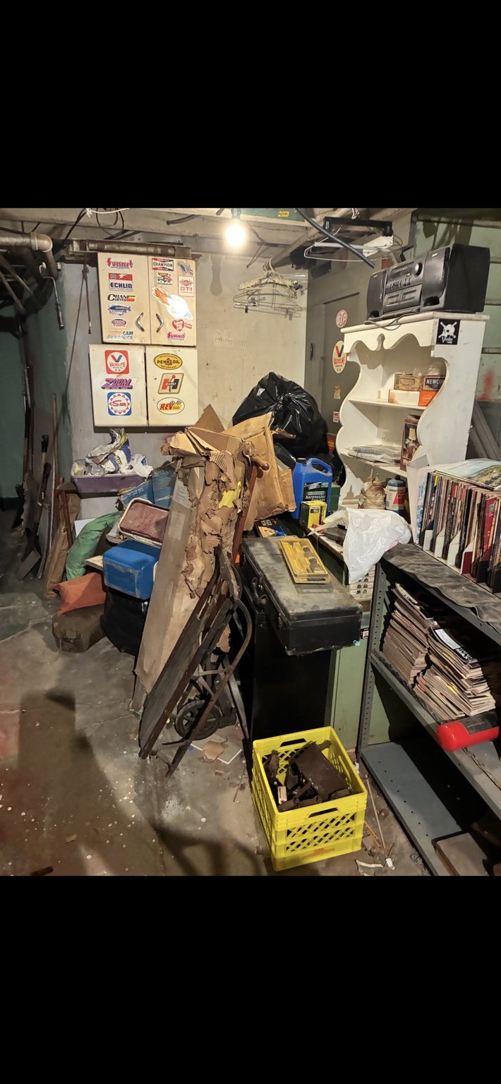Cluttered basement before cleanout