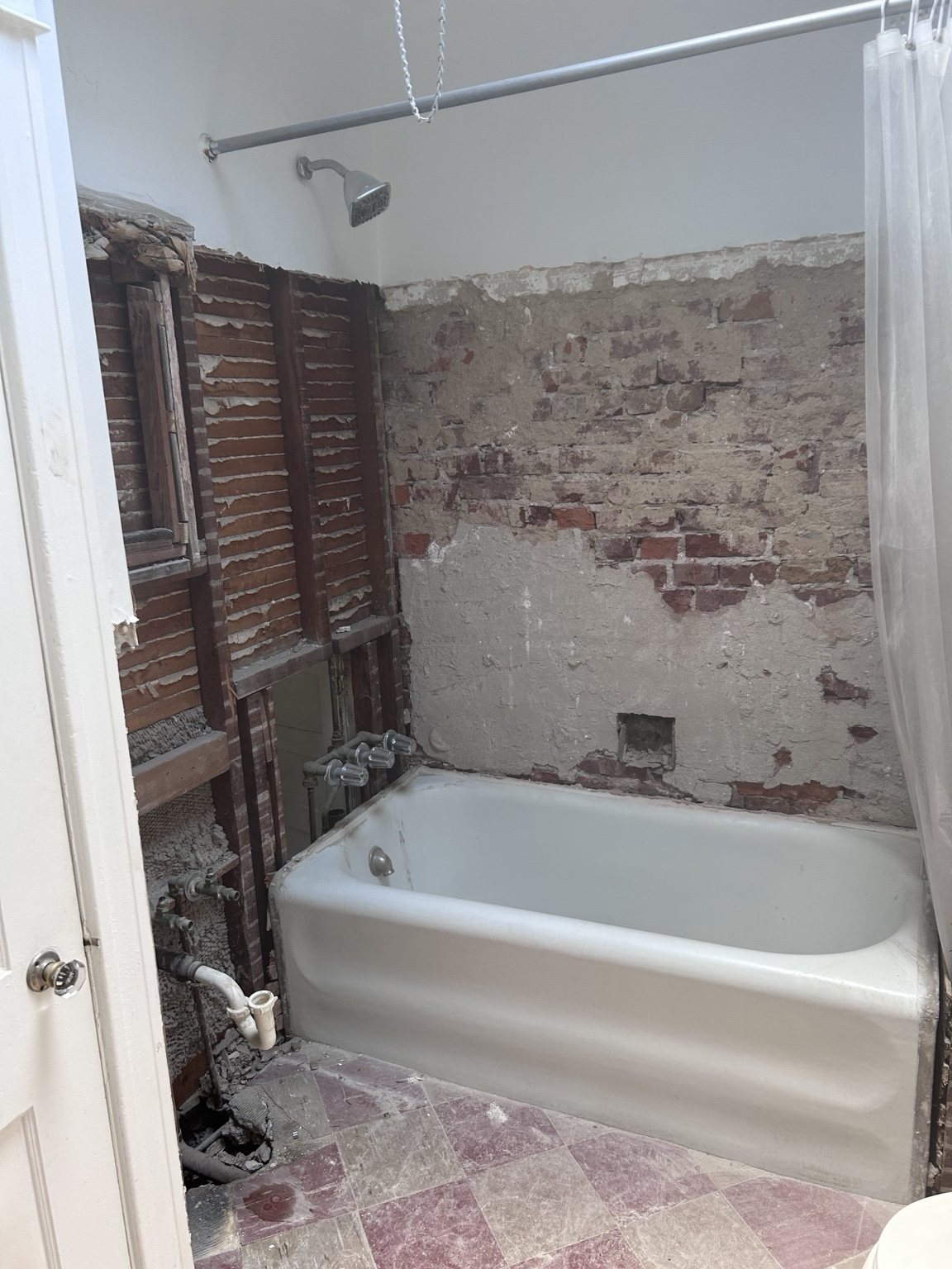 Bathroom with tile and wall finishes removed