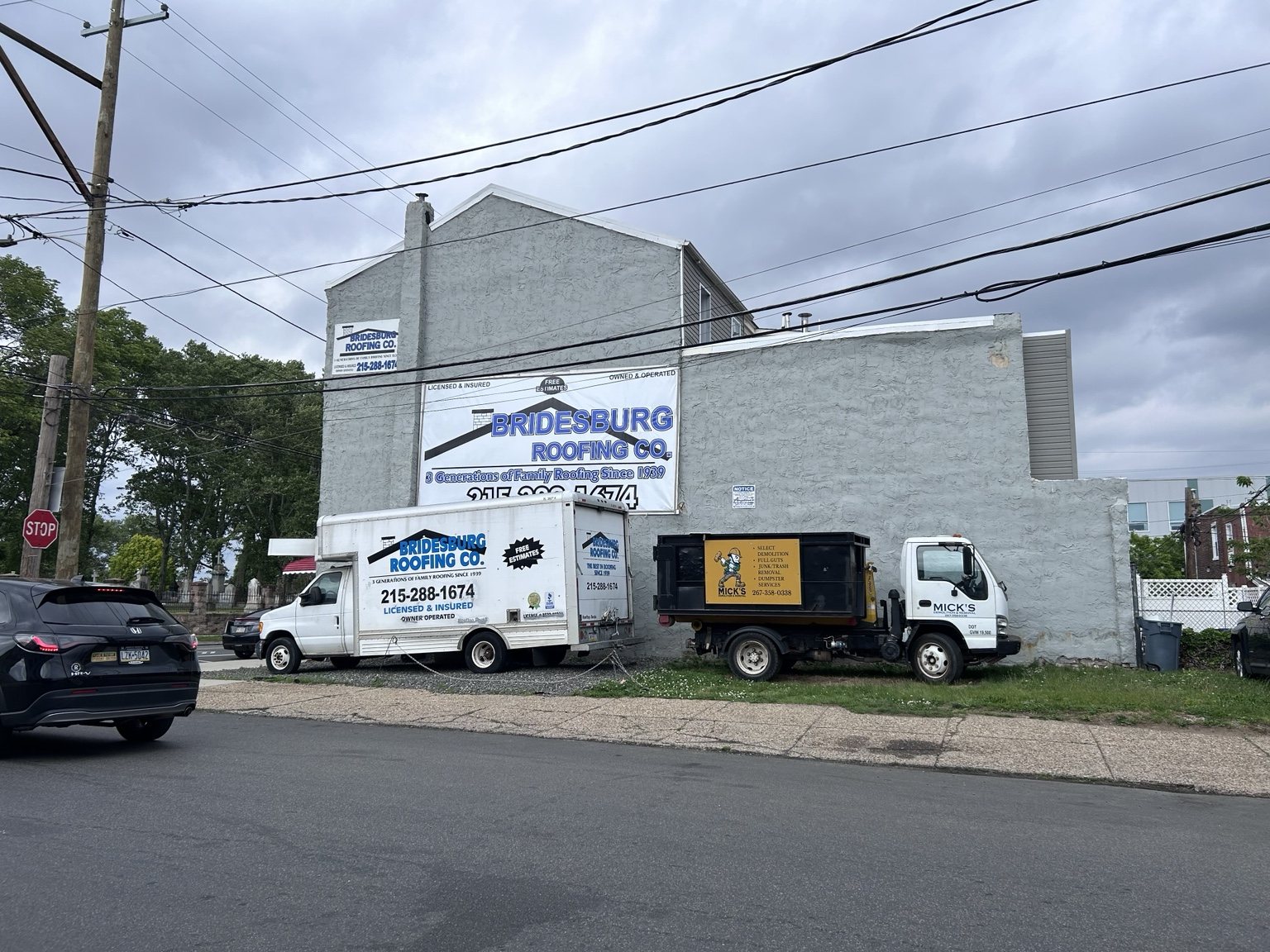 MICK'S truck parked beside a roofing contractor truck